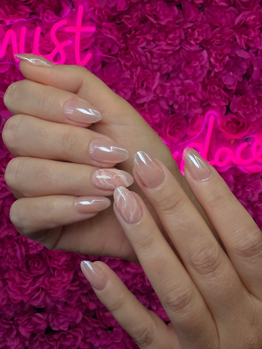 Glazed pearl almonds with a soft pink marble accent nails at Modish Nail Lounge Rancho Cucamonga