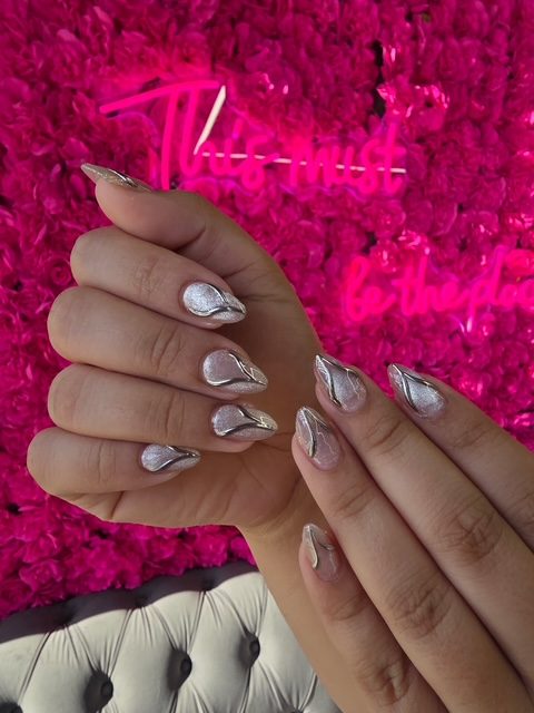 Pearl-silver shimmer with chrome swirl accents nails at Modish Nail Lounge Rancho Cucamonga