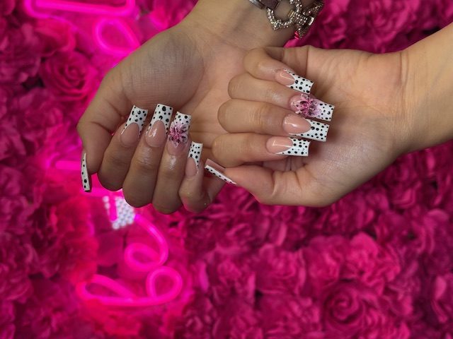 White French with black dots and pink 3D flowers nails at Modish Nail Lounge Rancho Cucamonga