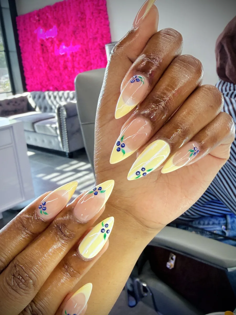 Butter yellow French with floral accents nails at Modish Nail Lounge Rancho Cucamonga