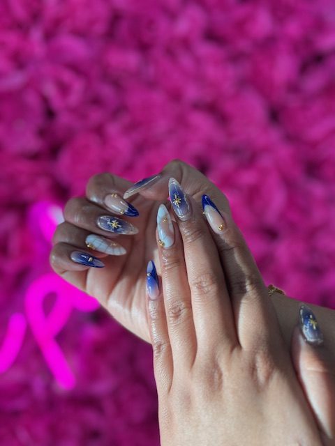 Blue marble with gold star accents nails at Modish Nail Lounge Rancho Cucamonga
