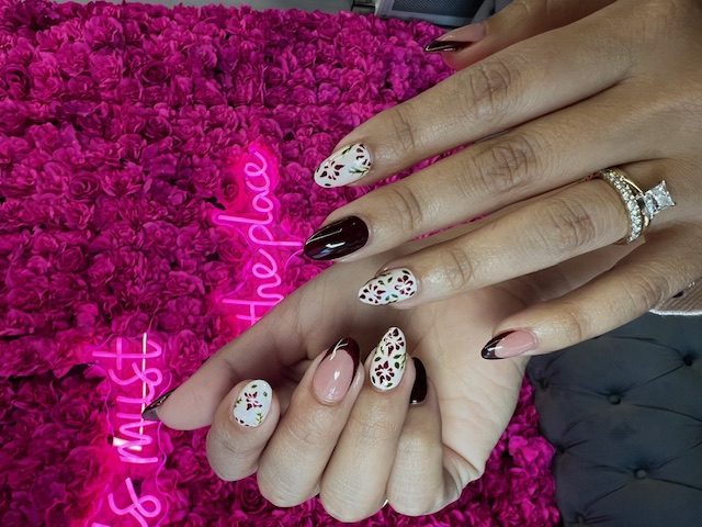 Burgundy and white with poinsettia florals nails at Modish Nail Lounge Rancho Cucamonga