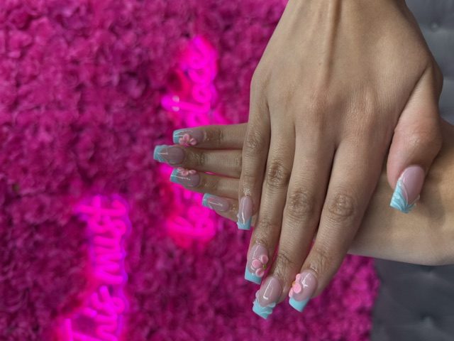 Baby blue French with pink 3D flowers nails at Modish Nail Lounge Rancho Cucamonga