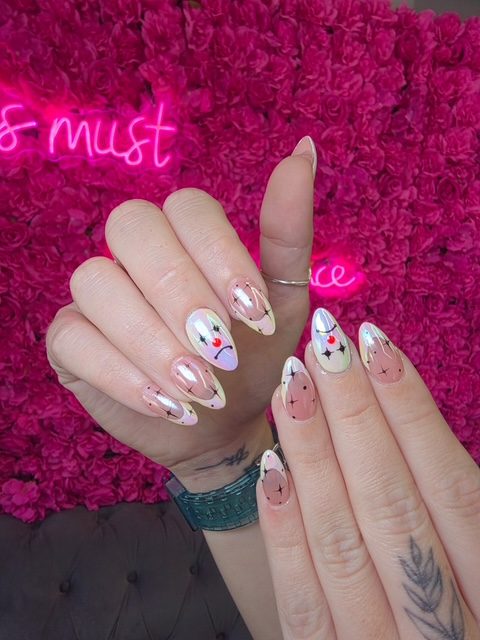 Pearl chrome with black celestial star accents nails at Modish Nail Lounge Rancho Cucamonga