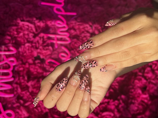 Pink leopard print with star charms and rhinestones nails at Modish Nail Lounge Rancho Cucamonga