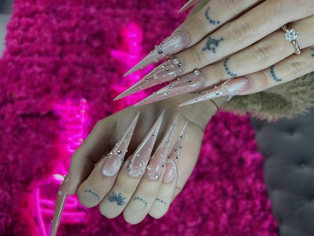 Extreme-length sheer pink with glitter and rhinestones nails at Modish Nail Lounge Rancho Cucamonga