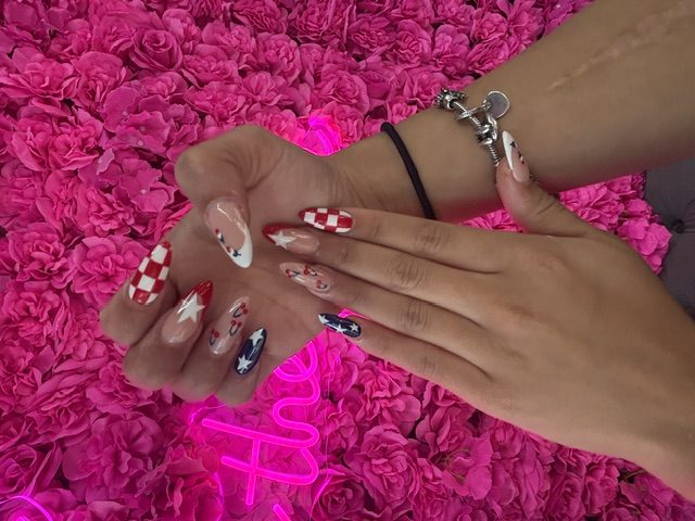 Red-white-blue Americana: checkerboard, stars, cow print nails at Modish Nail Lounge Rancho Cucamonga