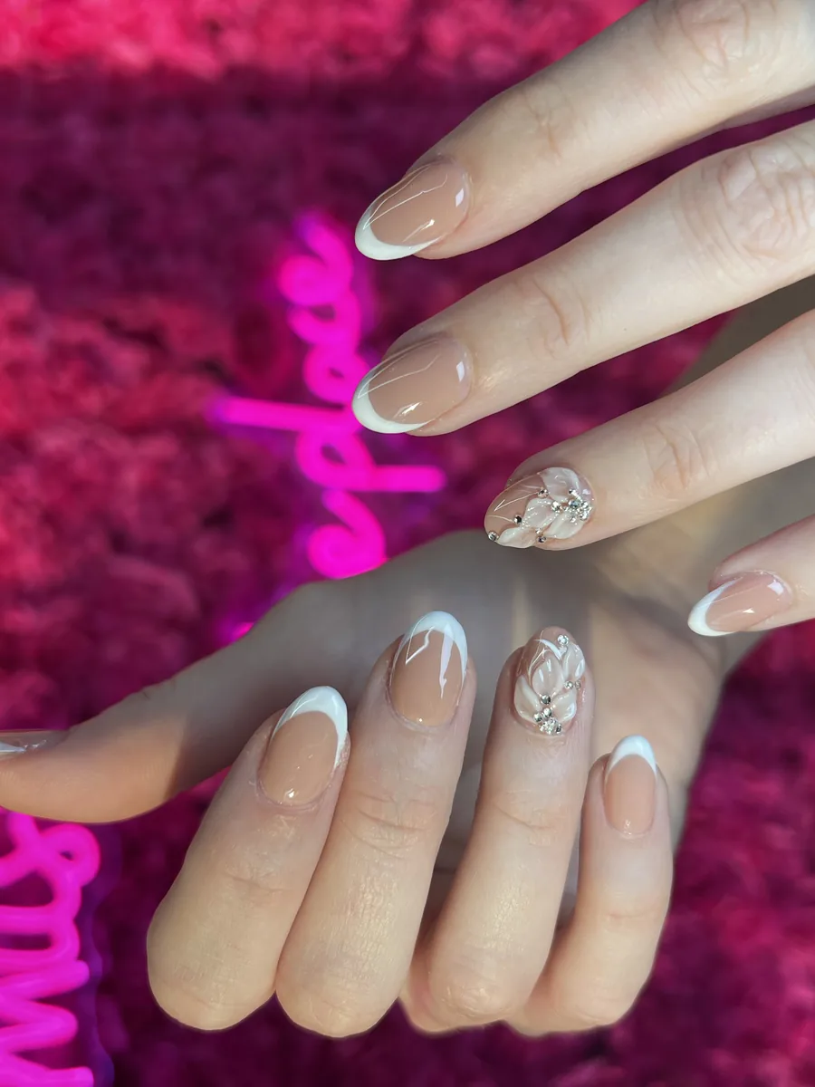 Nude almond French with 3D florals and rhinestones nails at Modish Nail Lounge Rancho Cucamonga