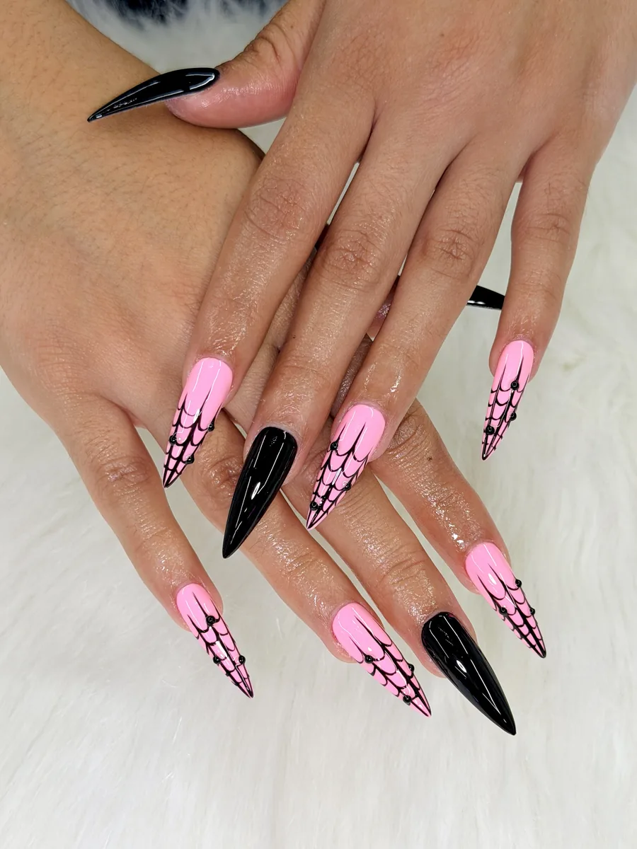 Bubblegum pink stilettos with black cow-print accents nails at Modish Nail Lounge Rancho Cucamonga