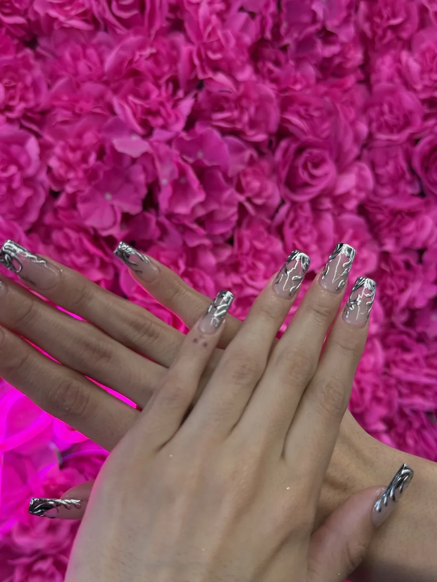 Liquid silver chrome swirls on long coffin nails at Modish Nail Lounge Rancho Cucamonga
