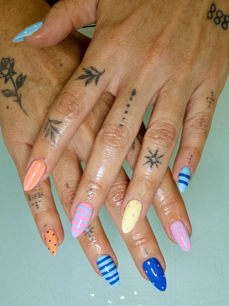 Pastel stripes and polka dots on long almonds nails at Modish Nail Lounge Rancho Cucamonga