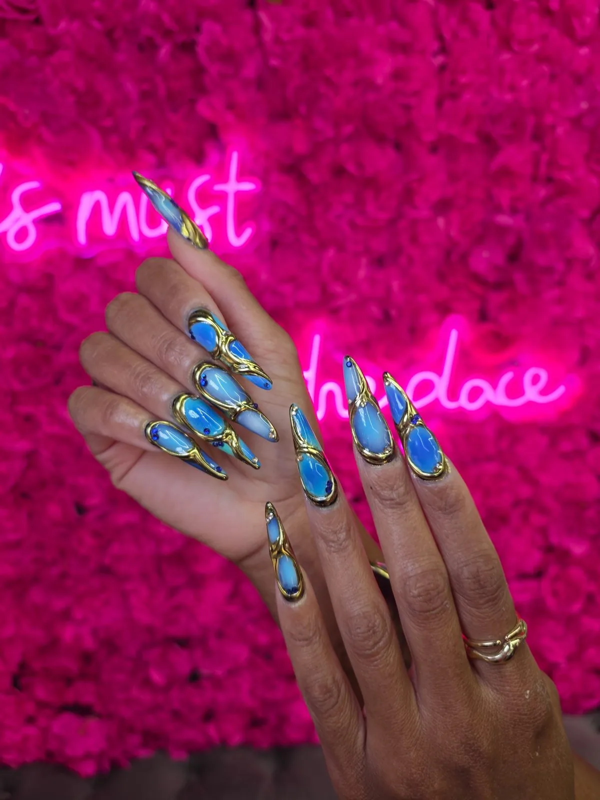 Blue gemstone stiletto nail art at Modish Nail Lounge Rancho Cucamonga