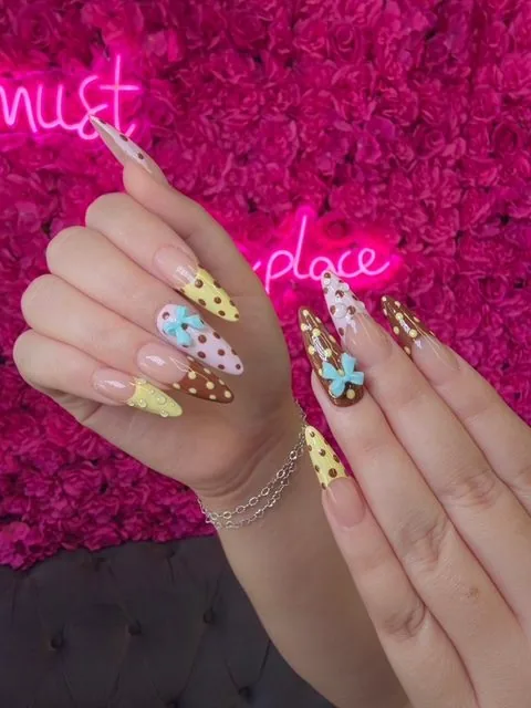 Yellow French tip nails at Modish Nail Lounge Rancho Cucamonga
