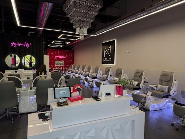 Interior of Modish Nail Lounge showing reception desk and pedicure chairs