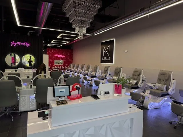 Interior of Modish Nail Lounge showing reception desk and pedicure chairs
